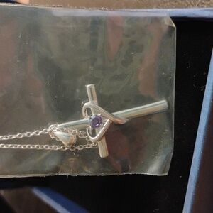 Silver cross necklace with purple stone
